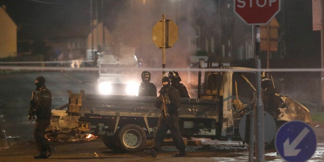 Police guard a crime scene during unrest in the Creggan area of Londonderry, in Northern Ireland, Thursday, April 18, 2019.