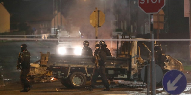 Police guard a crime scene during unrest in the Creggan area of Londonderry, in Northern Ireland, Thursday, April 18, 2019.