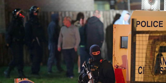 Armed police stage at the scene of unrest in Creggan, Londonderry, in Northern Ireland, Thursday, April 18, 2019.