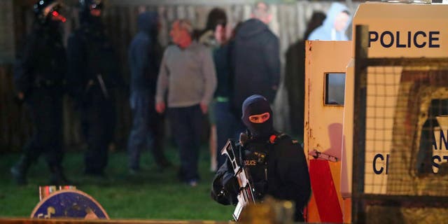 Armed police stage at the scene of unrest in Creggan, Londonderry, in Northern Ireland, Thursday, April 18, 2019.