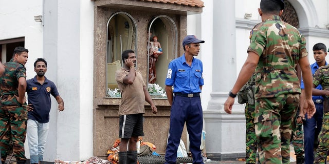 People gather outside St. Anthony's Shrine where a blast happened, in Colombo, Sri Lanka, Sunday, April 21, 2019. (Associated Press)