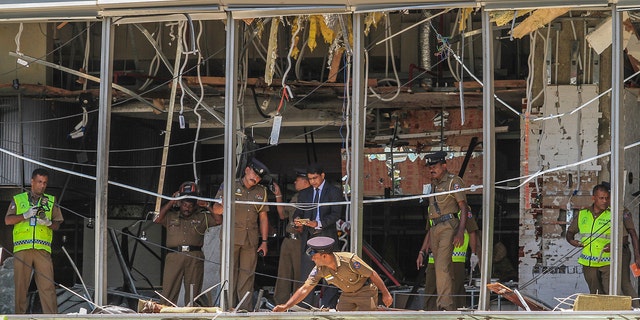 A Sri Lankan Police officer inspects a blast spot at the Shangri-la hotel in Colombo, Sri Lanka.