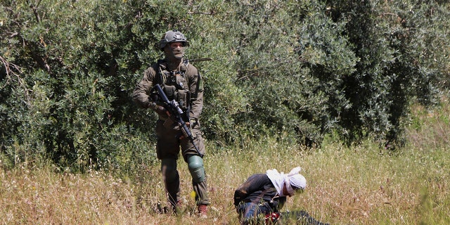 The military said it would investigate the incident as Palestinian youth threw stones at Israeli soldiers. (AP Photo / Mustafa Allbadan)