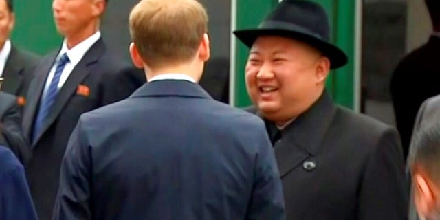North Korean leader Kim Jong Un smiles as he leaves a train in Vladivostok railway station in Vladivostok, Russia.