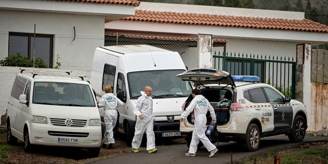 Members of the Spanish Civil Guard work on a road leading to a cave at the base of the Teide volcano, where a mother and son were found in Santa Cruz de Tenerife in the Canary Islands, Spain, Wednesday, April 24, 2019.