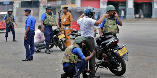 Sri Lankan navy soldiers perform security checks on motorists at a road in Colombo, Sri Lanka on Thursday. (AP Photo/Eranga Jayawardena)