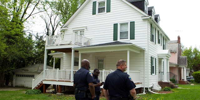 Baltimore police officers stand outside the house of Baltimore Mayor Catherine Pugh in Baltimore, MD., Thursday, April 25, 2019. Agents with the FBI and IRS are gathering evidence inside the two homes of Pugh and also in City Hall. (AP Photo/Jose Luis Magana)