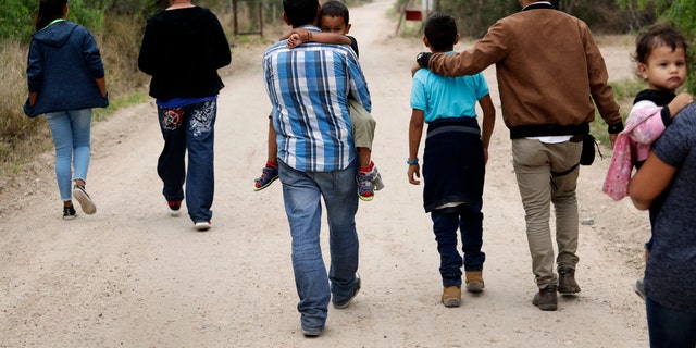 REPORT - In this 14 March 2019 photo, a group of migrant families was marching from the Rio Grande, the river separating the United States and Mexico from Texas, near McAllen, Texas, just before being apprehended by the patrol borders. US border officials say they have started increasing biometric data for children aged 13 and under, including fingerprints, despite privacy concerns and government policy to limit the information that can be collected from the United States. young migrants. (AP Photo / Eric Gay, File)