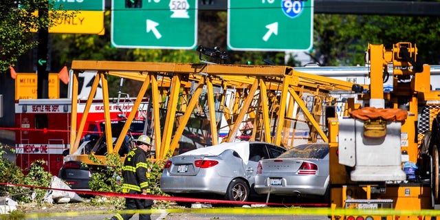 Emergency crews work the scene of a construction crane collapse near the intersection of Mercer Street and Fairview Avenue near Interstate 5 in Seattle.