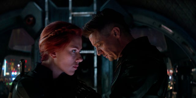 This image released by Disney shows Scarlett Johansson, left, and Jeremy Renner in a scene from 