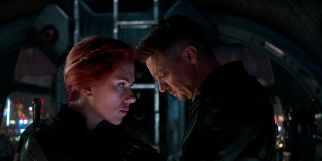 This image released by Disney shows Scarlett Johansson, left, and Jeremy Renner in a scene from