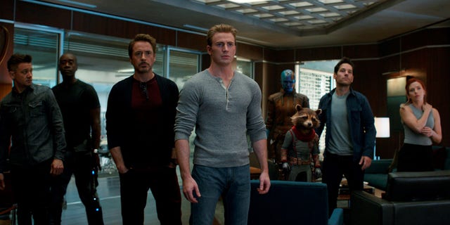 This image released by Disney shows, from left, Jeremy Renner, Don Cheadle, Robert Downey Jr., Chris Evans, Karen Gillan, the character Rocket, voiced by Bradley Cooper, Paul Rudd and Scarlett Johansson in a scene from "Avengers: Endgame."