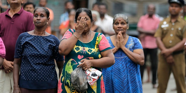 Sri Lankan Catholics pray standing on a road as they attend a brief holly service marking the seventh day of the Easter Sunday attacks near the exploded St. Anthony's Church in Colombo, Sri Lanka, Sunday, April 28, 2019. (AP Photo/Eranga Jayawardena)