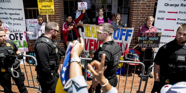 Activists from Code Pink, which protests U.S. support for Guaido, have been living and protesting at the embassy for weeks. On Tuesday, the organization asked supporters to “join us to uphold international law and protect the Venezuelan embassy from a hostile takeover.” (AP Photo/Andrew Harnik)