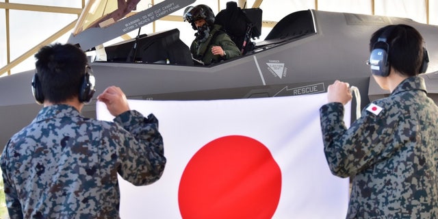 The Japan Air Self-Defense Force F-35A national pilot is sitting in the cockpit of one of the three F-35s in the ramp area of ​​the 944th Fighter Wing.