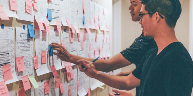 Bryan Chung, 25, and Brian Chung, 30, work on their creative process for a book of the Bible in their Los Angeles apartment.
