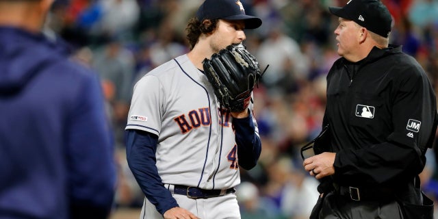 Pitcher Gerrit Cole and home plate umpire Ron Kulpa exchange words during the seventh inning.