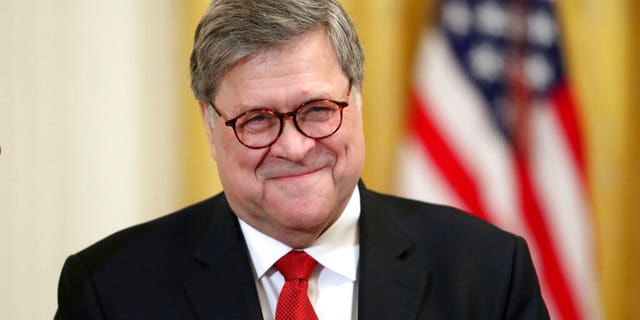 Attorney General William Barr smiles as he waits for President Donald Trump to speak at the 2019 Prison Reform Summit and First Step Act Celebration in the East Room of the White House in Washington, Monday, April 1, 2019. (AP Photo/Andrew Harnik)
