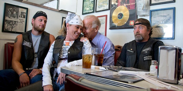 In this Sept. 9, 2012, file photo, Vice President Joe Biden talks to customers, including a woman who pulled up her chair in front of the bench Biden was sitting on, during a stop at Cruisers Diner in Seaman, Ohio. (AP Photo/Carolyn Kaster, File)