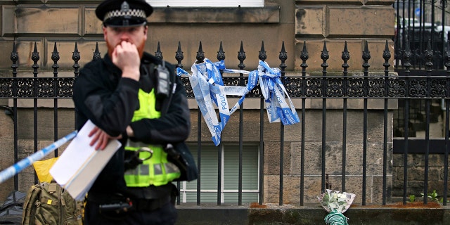 A floral tribute at the scene of the shooting of Bradley Welsh, in Edinburgh, Scotland, Thursday April 18, 2019.