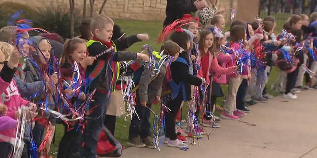 The kids of Frazier Elementary School cheered on police and fire escorts. (Fox 4)