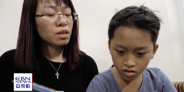 Ngocanh Le and her son, Minh Viet, look at the Superbook program that brings the Bible to life in an animated way. it was translated into their local Vietnamese language.