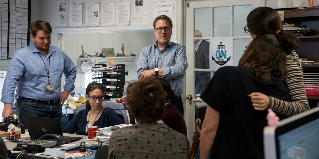 Capital Gazette Editor Rick Hutzell, center, speaks to staffers Monday as the paper won a special Pulitzer Prize citation for its coverage of a shooting that killed five of the paper's staffers. (Ulysses Muoz/The Baltimore Sun via AP)