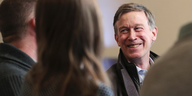 Former Democratic Colorado Governor John Hickenlooper smiles during a meeting with AmeriCorps members at a roundtable campaign stop in Manchester, N.H., Friday, March 22, 2019. Hickenlooper joined the 2020 Presidential race earlier in the month. (AP Photo/Charles Krupa)
