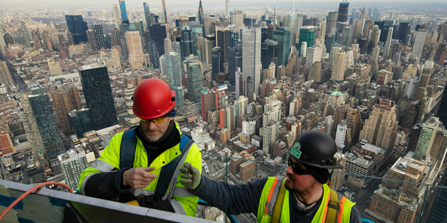 FILE- In this March 8, 2019, file photo, work continues on an outdoor observation deck on the 30 Hudson Yards office building in New York. On Monday, April 1, the Commerce Department reports on U.S. construction spending in February. (AP Photo/Mark Lennihan, File)