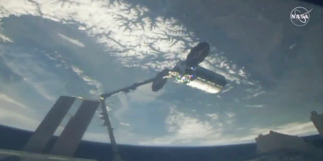 This photo provided by NASA shows a cargo ship arriving at the International Space Station, Friday, April 19, 2019. Space station astronaut Anne McClain used a robot arm to capture Northrop Grumman’s Cygnus capsule as they soared 258 miles (415 kilometers) above France. The Cygnus and its 7,600-pound (3,450-kilogram) shipment rocketed from Wallops Island, Va., on Wednesday, completing the trip in short order. (NASA via AP)
