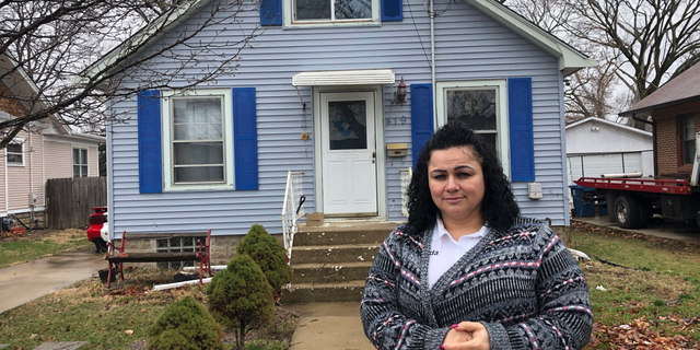 Linda Ramirez stands in front of her house in Aurora, Ill., Thursday, April 4, 2019, where she is waiting to learn if a 14-year-old who told police he is Timmothy Pitzen and had escaped kidnappers in the Cincinnati area is really him. Authorities conducted DNA testing to try to determine Thursday whether a teenager found wandering the streets of a Kentucky town is who he claims to be — an Illinois boy who disappeared eight years ago around the time his mother took her own life. (AP Photo/Carrie Antlfinger)