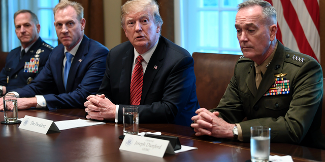 President Donald Trump, second from right, flanked by acting Defense Secretary Patrick Shanahan, second from left, and Chairman of the Joint Chiefs of Staff Gen. Joseph Dunford, right, speaks during a meeting with military leaders in the Cabinet Room of the White House in Washington, Wednesday, April 3, 2019. At left is Air Force Chief of Staff Gen. David Goldfein. (AP Photo/Susan Walsh)