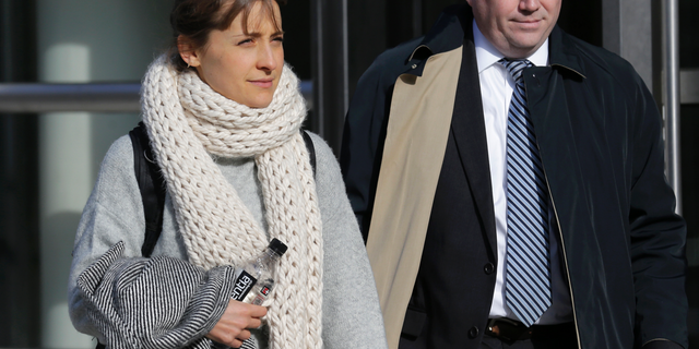 FILE - In this Dec. 6, 2018, file photo, television actress Allison Mack leaves federal court in New York. Jury selection is set to begin for a trial featuring sensational allegations that a cult-like group based in upstate New York turned women into sex slaves who were branded with the initials of its spiritual leader. Prosecutors say the purported self-help group called NXIVM formed a secret society of women who had unwanted sex with guru Keith Raniere. Raniere and three co-defendants including heiress Clare Bronfman and TV actress Allison Mack have pleaded not guilty to conspiracy and other charges in the sex-trafficking case. Potential jurors will be asked to fill out questionnaires Monday, April 8, 2019, in federal court in Brooklyn. (AP Photo/Seth Wenig, File)