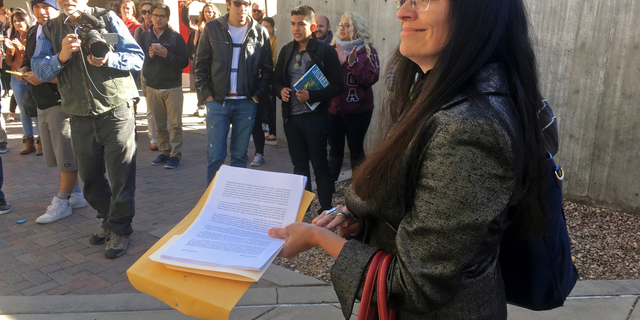 FILE - In this Nov. 18, 2016 file photo, University of New Mexico Chicana and Chicano studies professor Irene Vasquez holds a letter with hundreds of signatures, asking school president Bob Frank to declare the campus a "sanctuary university," in Albuquerque, N.M. Vasquez and other Mexican American scholars from universities across the country are gathering in Albuquerque on Wednesday, April 3, 2019, for an annual four-day national conference amid uncertainty on immigration and ethnic studies battles on college campuses. (AP Photo/Russell Contreras, File)