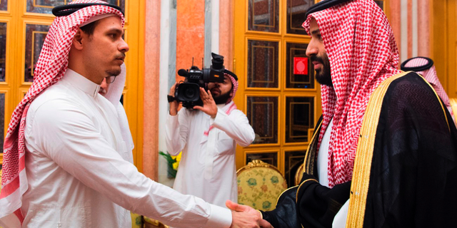 FILE - In this Oct. 23, 2018, file photo released by Saudi Press Agency, SPA, Saudi Crown Prince Mohammed bin Salman, right, shakes hands with Salah Khashoggi, a son, of Jamal Khashoggi, in Riyadh, Saudi Arabia. The son of slain Washington Post columnist Jamal Khashoggi says no settlement discussions have taken place and suggested that financial compensation to the family did not amount to an admission of guilt by Saudi rulers. Salah Khashoggi described King Salman and Crown Prince Mohammed bin Salman as “guardians to all Saudis.” (Saudi Press Agency via AP, File)
