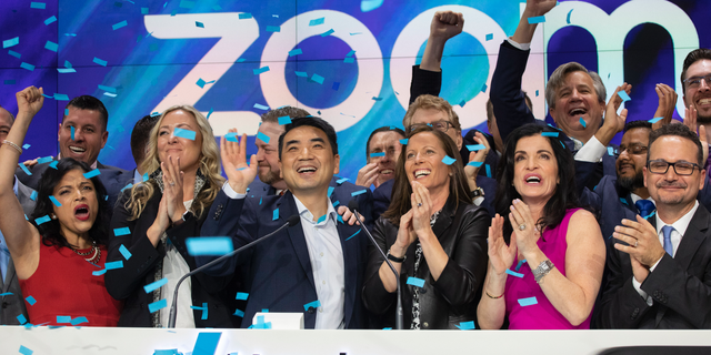 Zoom CEO Eric Yuan, center, celebrates the opening bell at Nasdaq as his company holds its IPO, Thursday, April 18, 2019, in New York. The videoconferencing company is headquartered in San Jose, Calif. - file photo.