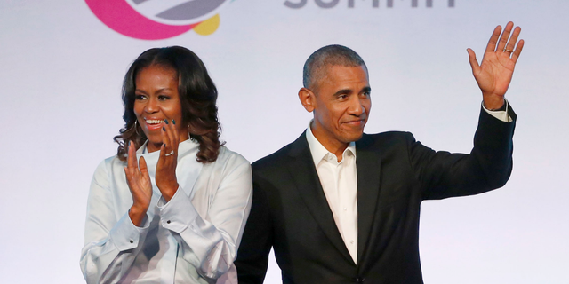 Former President Barack Obama, right, and former first lady Michelle Obama appear at the Obama Foundation Summit in Chicago. 