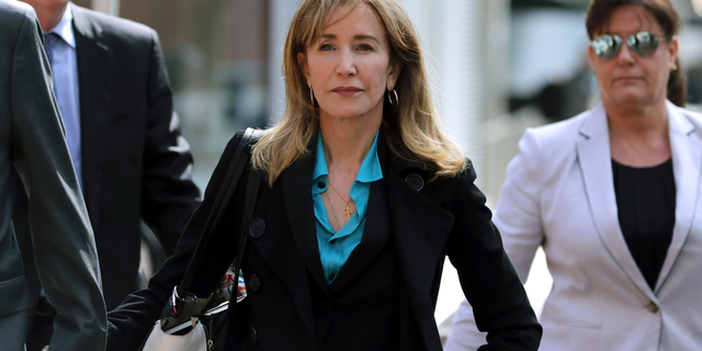 This April 3, 2019 file photo shows actress Felicity Huffman arriving at federal court in Boston to face charges in a nationwide college admissions bribery scandal. Huffman is facing a prison sentence after agreeing Monday to plead guilty to one count of conspiracy and fraud for paying a consultant $15,000 disguised as a charitable donation to boost her daughter’s SAT score. Prosecutors are seeking four to 10 months of confinement, and experts differ on whether the plea, and Huffman’s subsequent apology taking full responsibility for her actions, will lead to a career rebound or retreat. (AP Photo/Charles Krupa, File)