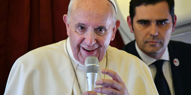 Pope Francis, flanked by interim director of Holy See Press Office, Alessandro Gisotti, speaks to reporters on board the flight back to Rome from a two-day trip to Morocco, Sunday, March 31, 2019. Francis sought Sunday to encourage greater fraternity between Christians and Muslims in Morocco, telling his flock that showing the country's Muslim majority they are part of the same human family will help stamp out extremism. (Alberto Pizzoli/Pool Photo via AP)