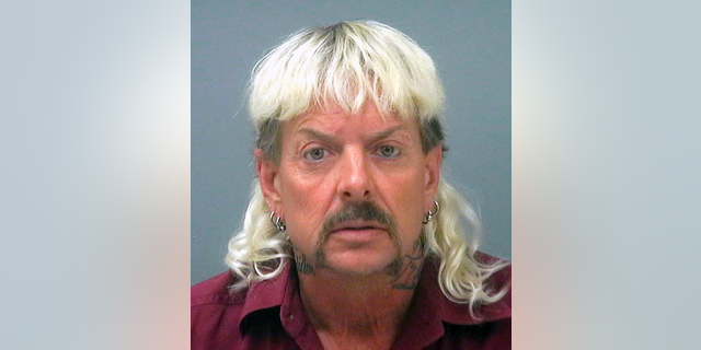 FILE - This file photo provided by the Santa Rose County Jail in Milton, Fla., shows Joseph Maldonado-Passage. Prosecutors say Maldonado-Passage, also known as "Joe Exotic, tried to arrange the killing of Carole Baskin, the founder of Big Cat Rescue. Lurors were shown a Facebook video Tuesday, March 26, 2019, that depicts Maldonado-Passage shooting a blow-up "Carole" doll in the head. Other videos show him pretending to dig a grave for Baskin and threatening to mail her rattlesnakes. (Santa Rosa County Jail via AP, File)