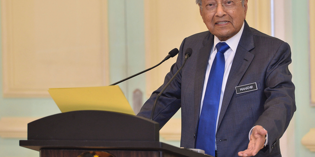 Malaysian Prime Minister Mahathir Mohamad speaks during a press conference at prime minister office in Putrajaya, on Friday, April 5, 2019. Mahathir says Malaysia will withdraw from endorsing another U.N. treaty, caving in to political pressure after a powerful state sultan joined the opposition to oppose the move. (AP Photo/Jeffery Ong)