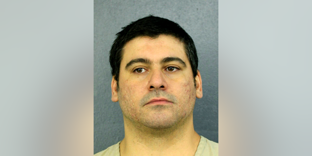 This Tuesday, April 10, 2019 photo made available by Broward County Sheriff's office, Fla., shows Luis Alberto Ferri under arrest. Ferri turned himself in to authorities less than a week after investigators released a video showing him intentionally driving his vehicle into a pedestrian. The victim suffered a broken leg. Ferri is charged with aggravated battery. (Broward County Sheriff's office via AP)