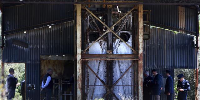 Cypriot investigators and police officers search a flooded mineshaft where two female bodies were found, outside of Mitsero village, near the capital Nicosia, Cyprus, Monday, April 22, 2019. Police on the east Mediterranean island nation, along with the help of the fire service, are conducting the search Monday in the wake of last week's discovery of the bodies in the abandoned mineshaft and the disappearance of the six-year-old daughter of one of the victims.