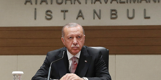 Turkey's President Recep Tayyip Erdogan talks to members of the media regarding the local elections, in Istanbul, Monday, April 8, 2019, prior to his departure for Russia. Erdogan has defended his ruling party's move to demand a full recount of votes cast in mayoral elections in Istanbul, claiming that "almost all" of the voting was marred by irregularities. Erdogan suffered a major setback in last week's local elections after the opposition took control of the capital Ankara and won a tight race for Istanbul. (Presidential Press Service via AP, Pool)