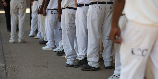 FILE- In this June 18, 2015 file photo, prisoners stand in a crowded lunch line during a prison tour at Elmore Correctional Facility in Elmore, Ala. he Justice Department has determined that Alabama's prisons are violating the Constitution by failing to protect inmates from violence and sexual abuse and by housing them in unsafe and overcrowded facilities, according to a scathing report Wednesda, April 3, 2019, that described the problems as "severe" and "systemic.". (AP Photo/Brynn Anderson)