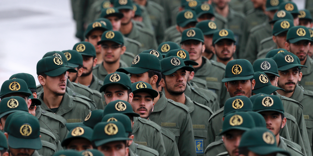 FILE - In this Feb, 11, 2019 file photo, Iranian Revolutionary Guard members arrive for a ceremony celebrating the 40th anniversary of the Islamic Revolution, at the Azadi, or Freedom, Square, in Tehran, Iran. President Donald Trump's administration is preparing to designate Iran's Revolutionary Guard as a "foreign terrorist organization." It's an unprecedented move that could have widespread implications for U.S. personnel and policy in the Mideast and elsewhere. U.S. officials say an announcement is expected Monday. (AP Photo/Vahid Salemi)