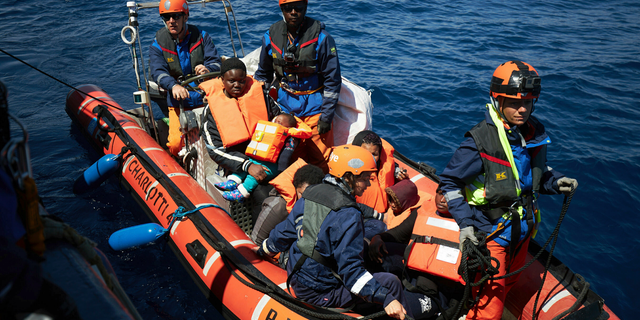 This April 3, 2019 photo shows migrants on a rubber dinghy rescued by the Sea-Eye rescue ship in the waters off Libya. The humanitarian ship Sea-Eye with 64 rescued migrants aboard was stuck at sea on Thursday as Italy and Malta refuse it safe harbor as their refusal set the stage for another Mediterranean standoff that can only be resolved if European governments agree to accept the asylum-seekers.