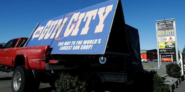 A billboard advertises a gun shop in Christchurch, New Zealand, Monday, April 1, 2019. New Zealand's government has introduced a bill to ban the types of weapons used by a terrorist to kill 50 people at two mosques. (AP Photo/Mark Baker)