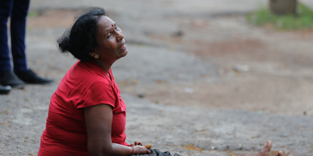 A relative of a blast victim grieves outside a morgue in Colombo, Sri Lanka, Sunday, April 21, 2019. More than hundred were killed and hundreds more hospitalized with injuries from eight blasts that rocked churches and hotels in and just outside of Sri Lanka's capital on Easter Sunday, officials said, the worst violence to hit the South Asian country since its civil war ended a decade ago. [AP Photo/Eranga Jayawardena)