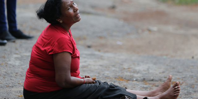 A relative of a blast victim grieves outside a morgue in Colombo, Sri Lanka, Sunday, April 21, 2019. More than hundred were killed and hundreds more hospitalized with injuries from eight blasts that rocked churches and hotels in and just outside of Sri Lanka's capital on Easter Sunday, officials said, the worst violence to hit the South Asian country since its civil war ended a decade ago. [AP Photo/Eranga Jayawardena)